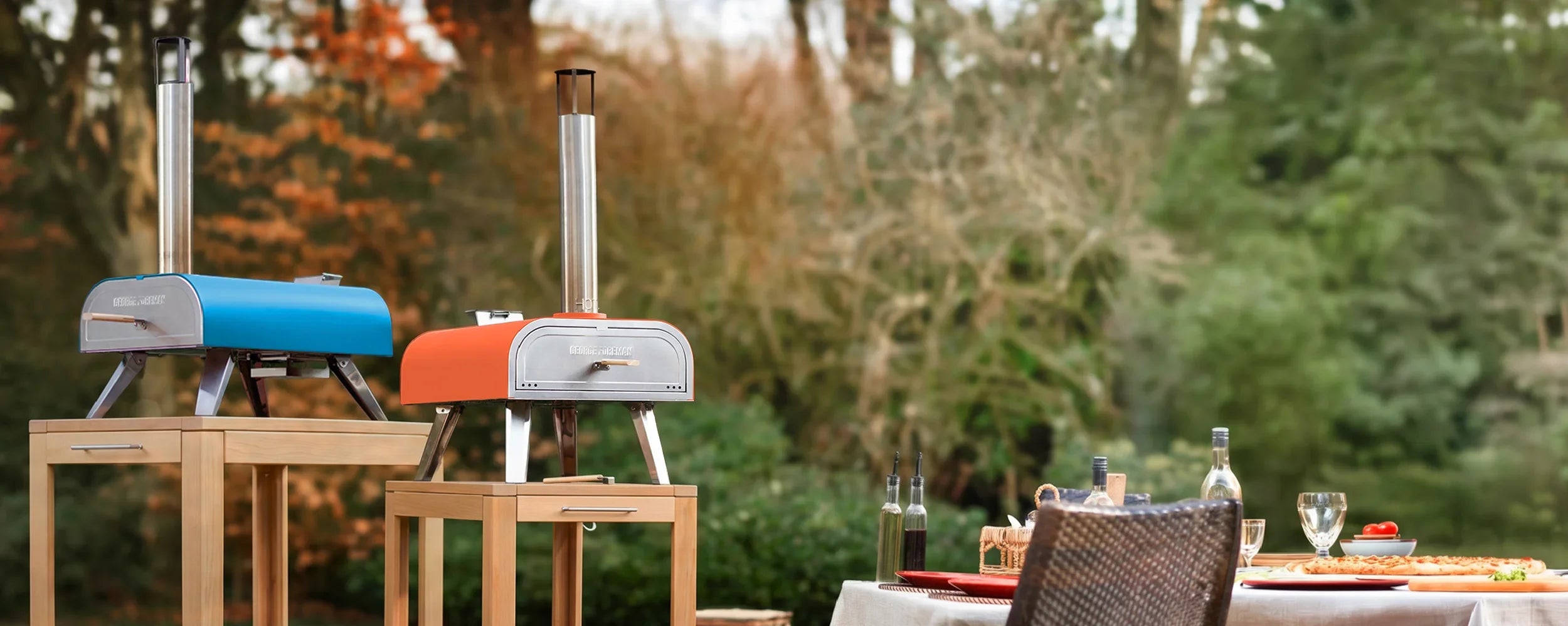 two pizza ovens in a garden setting with table set of r al fresco dining