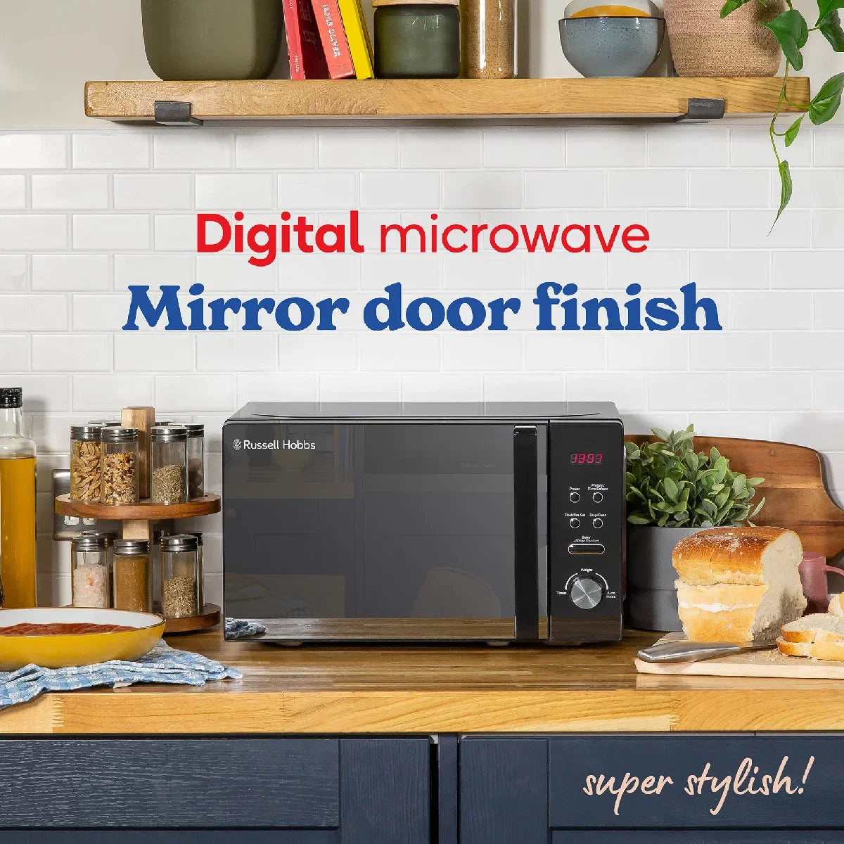 Digital microwave with mirror door finish on a kitchen counter, surrounded by kitchen items.