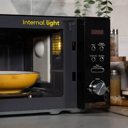Black microwave oven with a yellow bowl inside, labeled 'Internal light', on a kitchen counter.