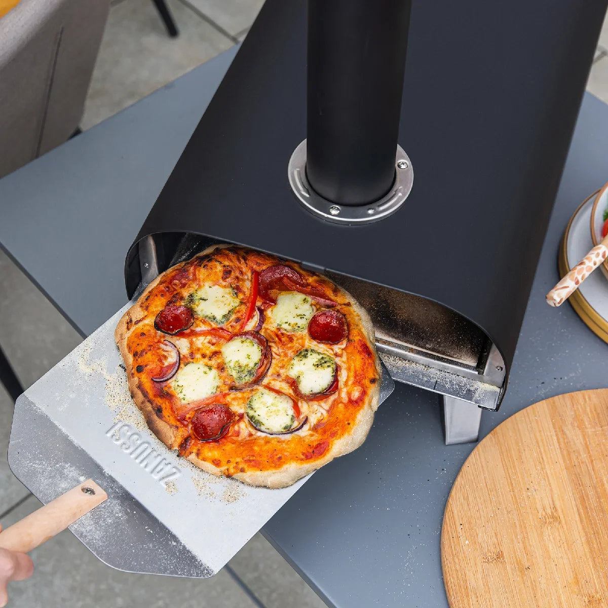 Zanussi ZPO1BPC Wood Pellet Pizza Oven with Paddle and Cover in Black
